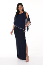 Woman wearing a navy blue dress with white accents on a white background