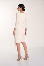 Woman wearing a white dress with a plain background
