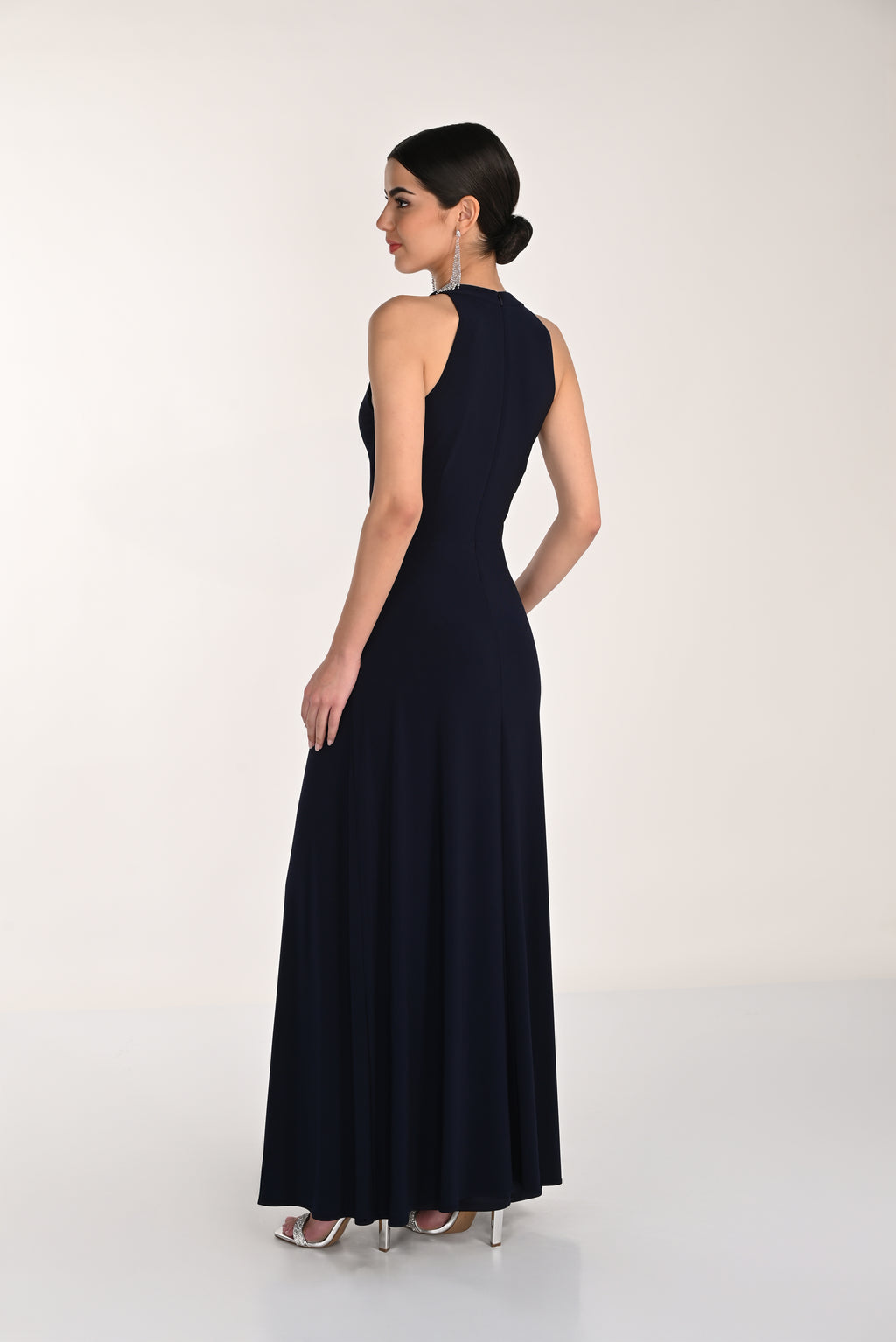 Woman wearing a navy blue evening gown on a white background