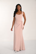 Woman wearing a pink gown against a white background