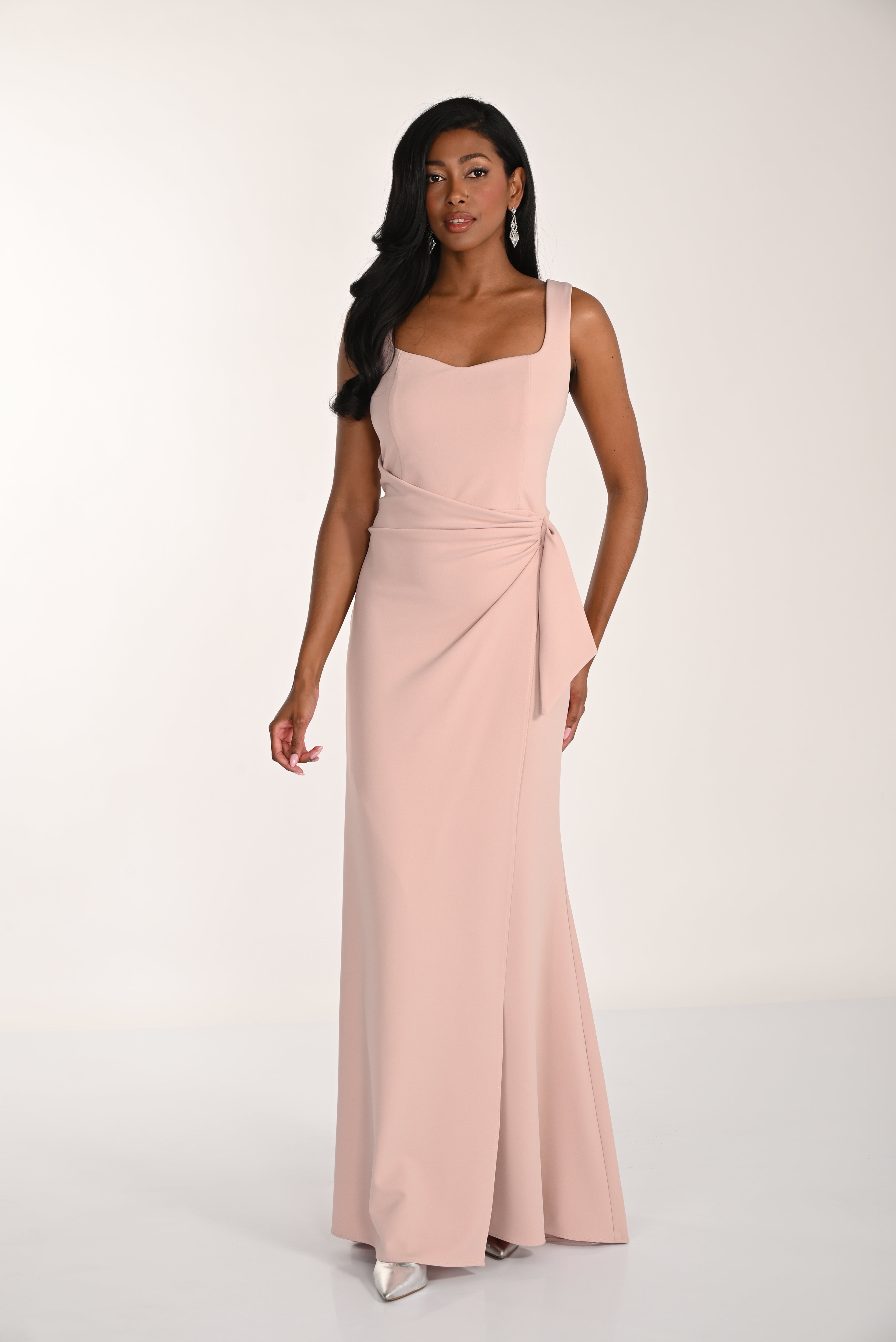 Woman wearing a pink gown against a white background