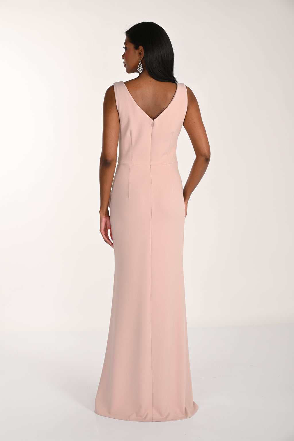Woman wearing a long pink dress on a white background