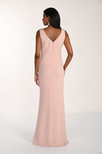 Woman wearing a long pink dress on a white background