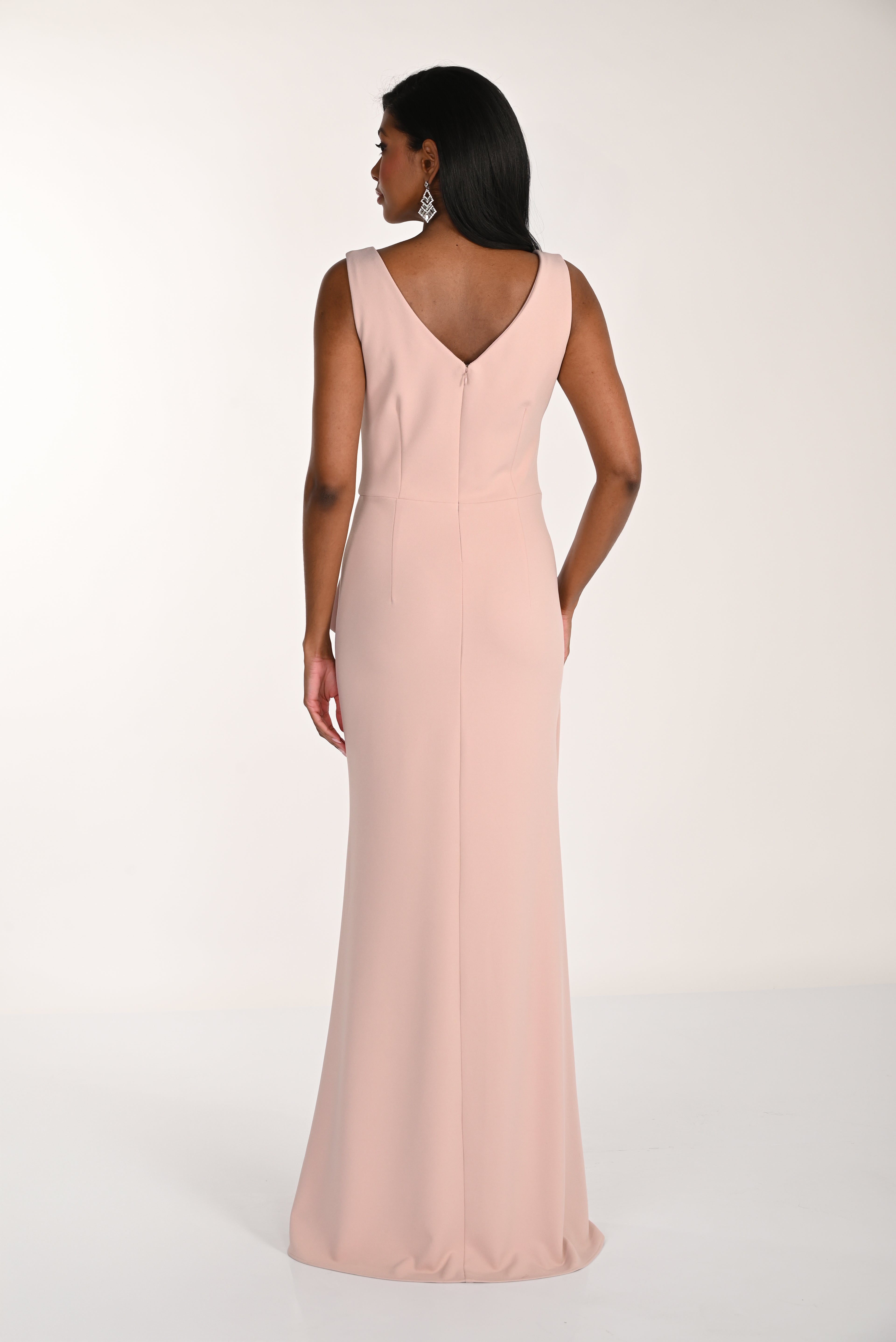 Woman wearing a long pink dress on a white background