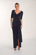 Woman wearing a dark blue evening gown with a V-neckline and quarter sleeves on a white background