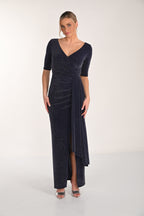 Woman wearing a dark blue evening gown with a V-neckline and quarter sleeves on a white background