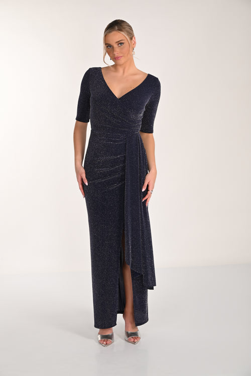 Woman wearing a dark blue evening gown with a V-neckline and quarter sleeves on a white background