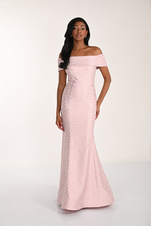 Woman wearing a pink off-shoulder gown against a white background