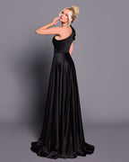 Woman wearing a black evening gown against a gray background