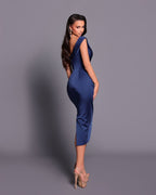Woman wearing a blue dress against a gray background