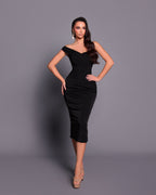 Woman wearing a black dress against a gray background