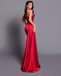 Woman wearing a red evening gown against a gray background