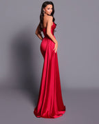 Woman wearing a red evening gown against a gray background