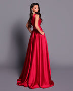 Woman wearing a red evening gown against a gray background