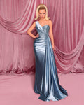 Woman in a silver evening gown standing against a pink curtain backdrop