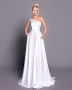 Woman wearing a white one-shoulder gown against a gray background