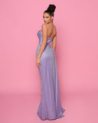 Woman in a strapless purple gown against a pink background