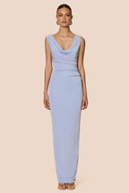 Woman wearing a light blue dress on a beige background