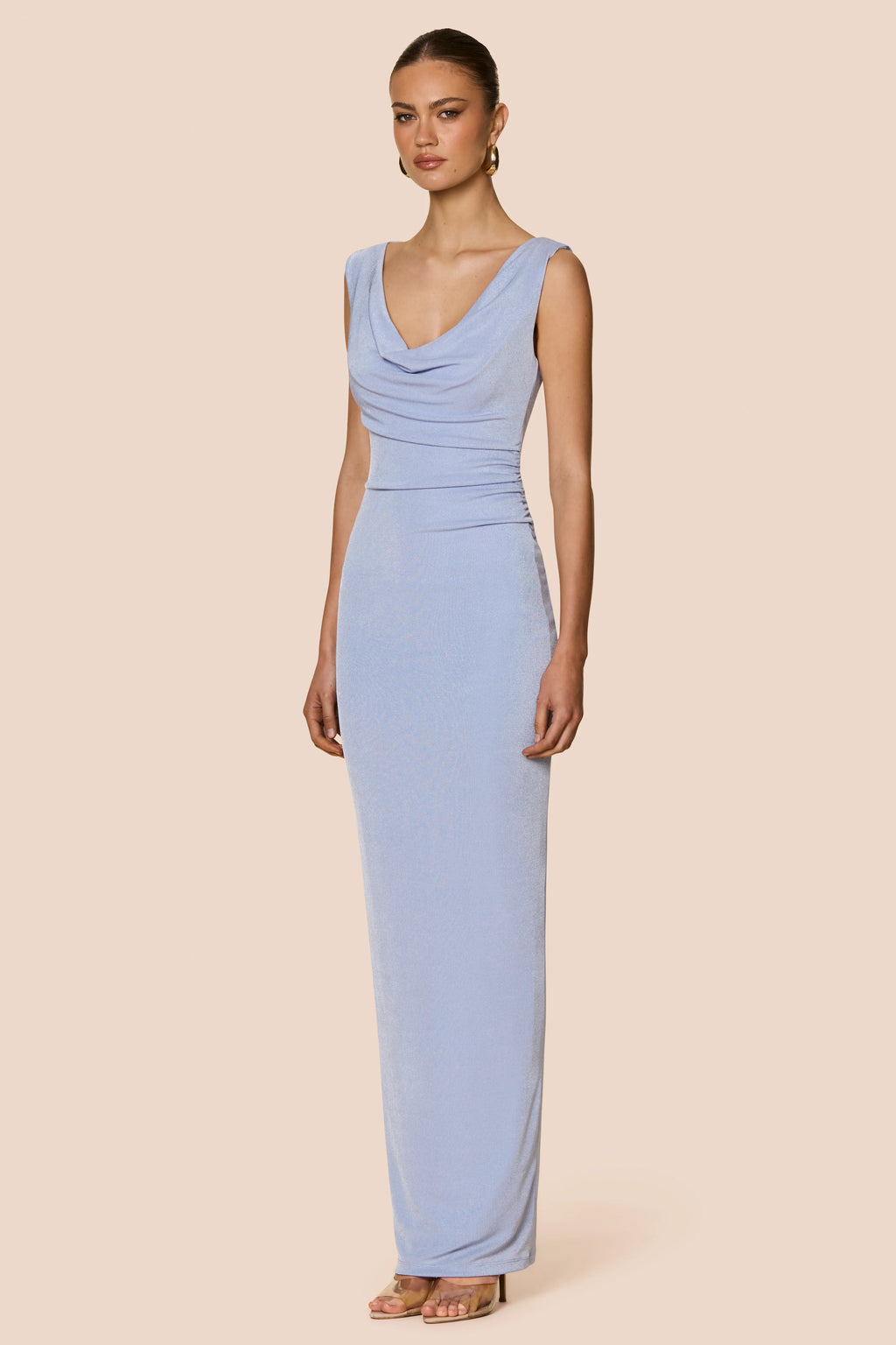 Woman wearing a light blue dress against a beige background