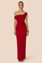Woman wearing a red one-shoulder dress on a beige background