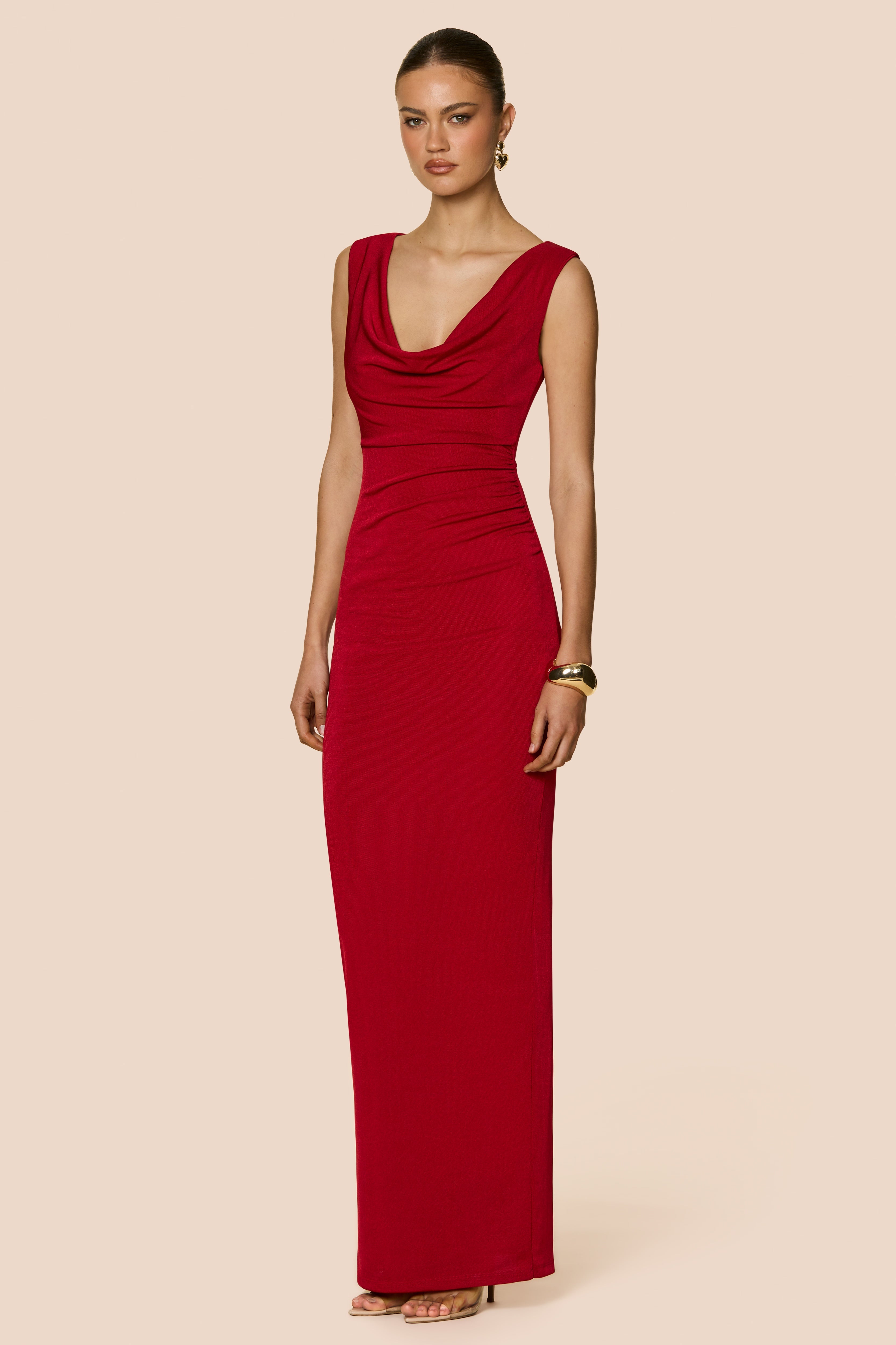 Woman wearing a red dress on a beige background