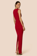 Red evening gown with a high slit on a beige background