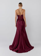Burgundy evening gown with a lace-up back on a white background