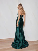 Woman wearing a green evening gown with a white background