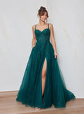 Woman wearing a green evening gown with a high slit on a white background
