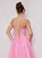 Pink dress with criss-cross back design on a light background
