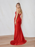 Woman wearing a red evening gown with a white background