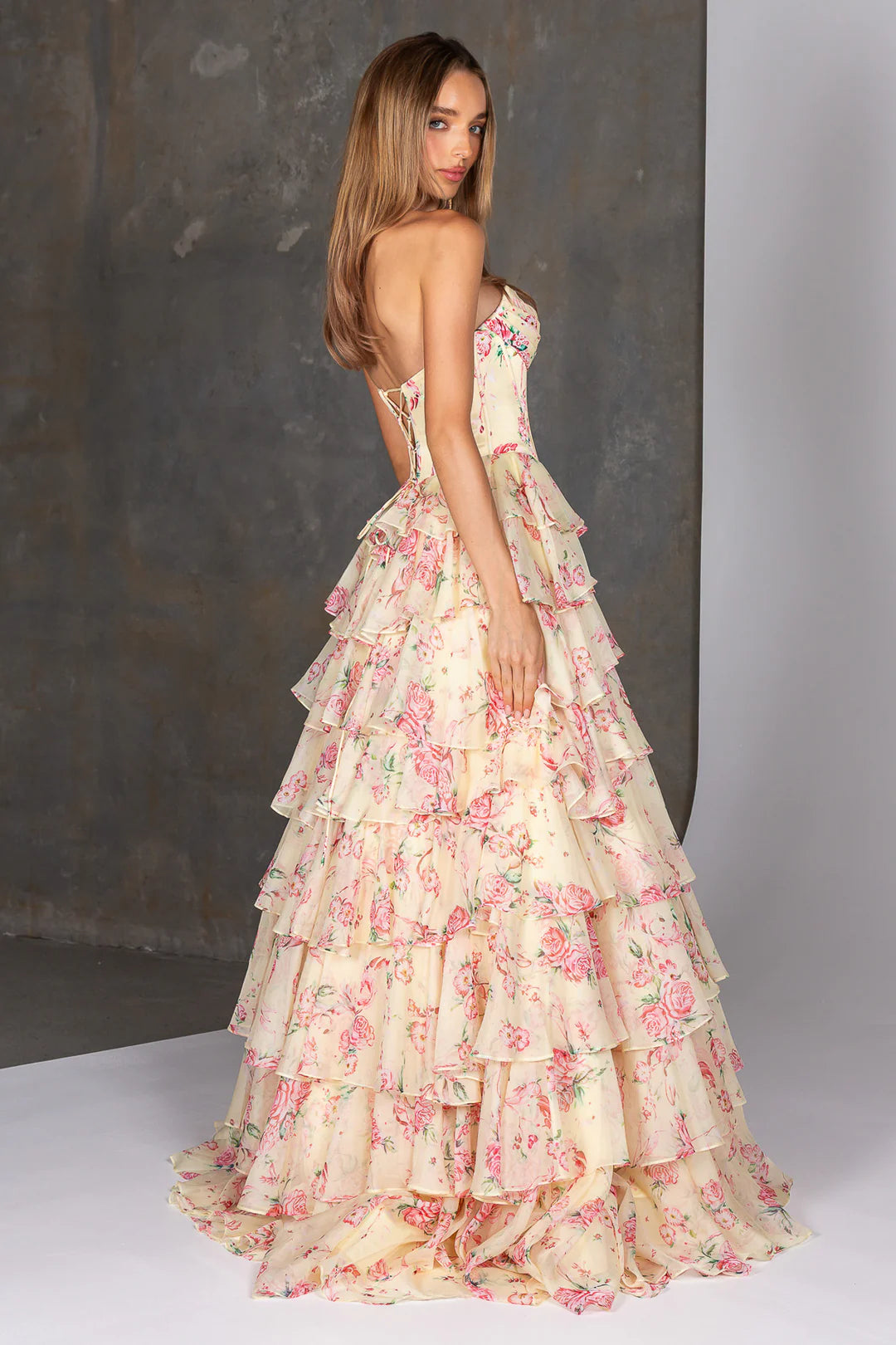 Woman wearing a floral dress with a plain background