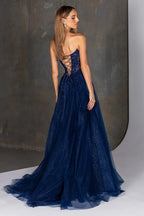 Navy blue evening gown with intricate lace details on a neutral background