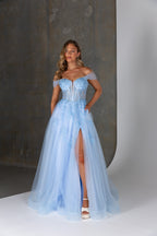 Woman wearing a light blue evening gown with a high slit on a neutral background
