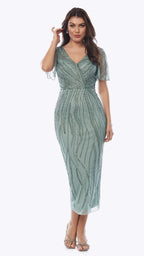 Woman wearing a green beaded dress on a white background