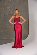 Woman wearing a red evening gown against a neutral background