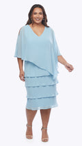 Woman wearing a light blue layered dress on a white background