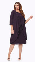 Woman wearing a dark purple dress with a draped front on a white background