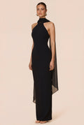 Black evening gown with sheer sides on a beige background