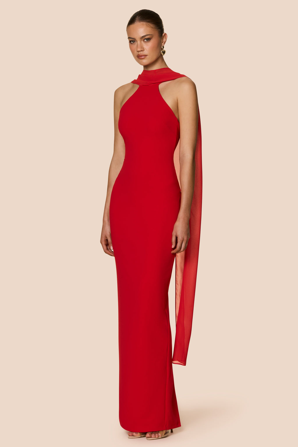 Red halter neck gown on a beige background