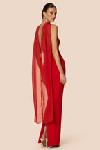 Red dress with open back on a beige background