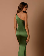 Woman wearing a green satin dress against a brown background