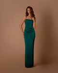 Woman wearing a green evening gown against a brown background