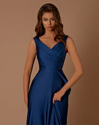 Woman wearing a blue evening gown against a brown background