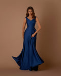 Woman wearing a blue evening gown against a brown background
