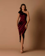 Woman wearing a one-shoulder dress with a draped design on a beige background