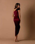 Woman wearing a burgundy one-shoulder dress against a brown background