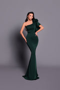 Woman wearing a green one-shoulder dress against a gray background