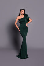 Woman wearing a green one-shoulder dress against a gray background