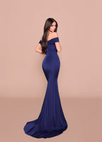 Woman wearing a blue off-shoulder gown against a beige background